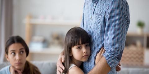 a child hugging her parent